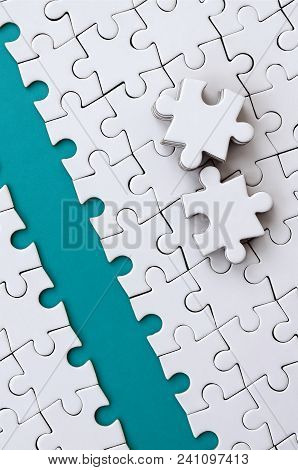 The Blue Path Is Laid On The Platform Of A White Folded Jigsaw Puzzle. The Missing Elements Of The P