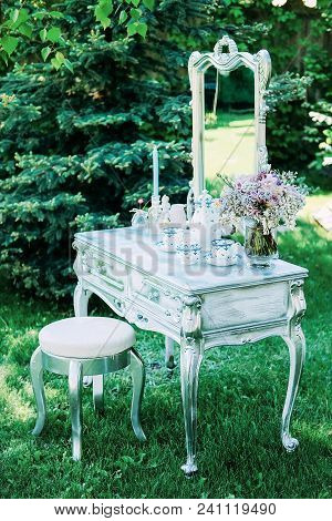 Decorated Console Mirror With Candles, Perfume Bottles And Other Makeup