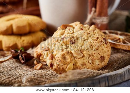 Conceptual Composition With Assortment Of Cookies On Burlap Napkin Covering A Wooden Barrel Over Rus