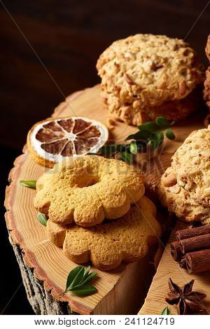 Christmas Concept With Asoortment Of Delicious Sweet Cookies, Cinnamon Sticks Bunch, A Couple Of Dri