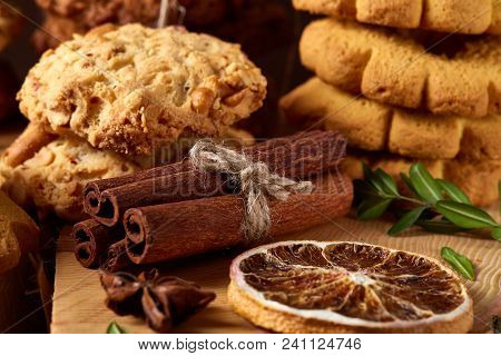 Christmas Concept With Asoortment Of Delicious Sweet Cookies, Cinnamon Sticks Bunch, A Couple Of Dri