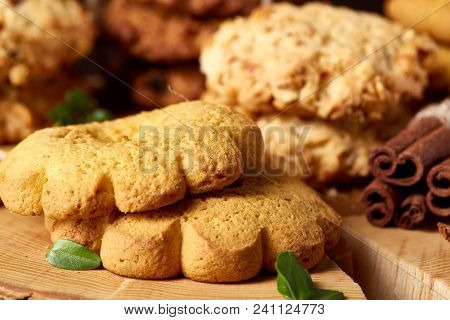 Christmas Concept With Asoortment Of Delicious Sweet Cookies, Cinnamon Sticks Bunch, A Couple Of Dri