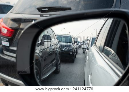 Reflection Of Traffic Flow In Left Side Rear View Mirror At Rush Hour