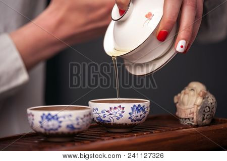 Cropped Shot Of Woman Holding Chawan With Green Oolong.