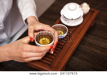 Cropped Shot Of Woman Holding Chawan With Green Oolong.