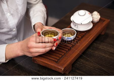Cropped Shot Of Woman Holding Chawan With Green Oolong.