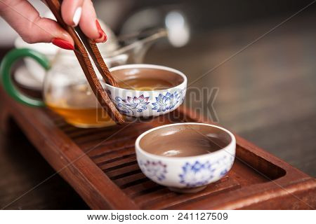 Cropped Shot Of Woman Holding Chawan With Green Oolong.