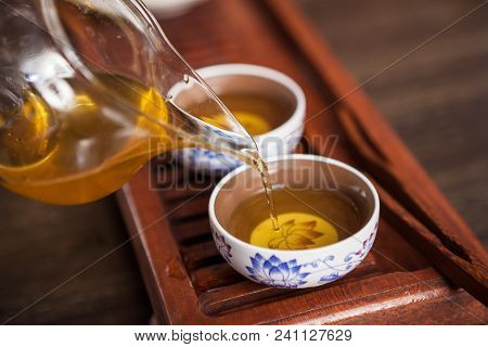 Cropped Shot Of Woman Holding Chawan With Green Oolong.