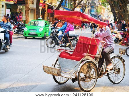 Hanoi, Vietnam - February 21, 2016: Cycle Rickshaw On Busy Street In Hanoi, Vietnam