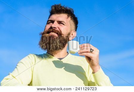 Man With Long Beard Enjoy Coffee. Man With Beard And Mustache On Smiling Face Drinks Coffee, Blue Sk