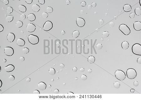 Rain Drops On Window Glasses Surface With Cloudy Background . Natural Pattern Of Raindrops Isolated 