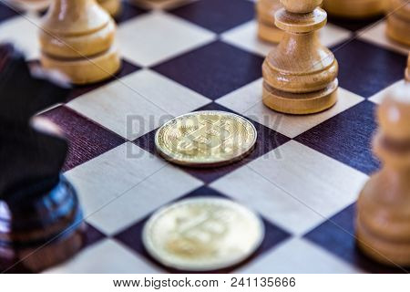 Golden Bitcoin Coins Symbolizes Elements Of Virtual Economy Or Crypto Currency With Chess Board