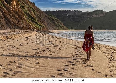 Young Girl Walking On The Beach Of Cabo Ledo. Angola. Africa.