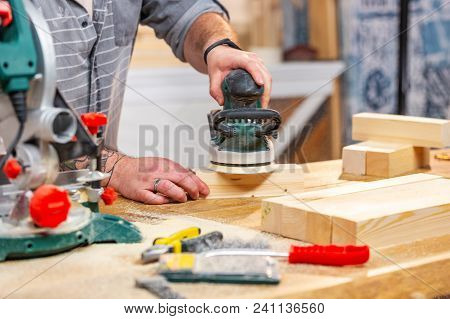 Working With Sanding Wood Bars Rotary Machine For Grinding On A Workbench In Motion