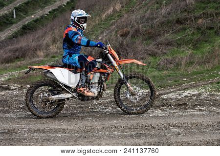 Biker Is Rides On His Colorful Sport Motorcycle On Summer Street. Man Wearing Protective For Bikers.