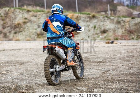 Biker Is Rides On His Colorful Sport Motorcycle On Summer Street. Man Wearing Protective For Bikers.