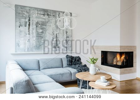 Black Blanket Thrown On Grey Corner Lounge In White Living Room Interior With Fireplace, Fresh Tulip