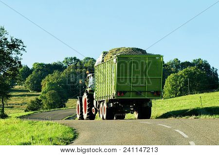 Ouhans, France - August, 25, 2016: Tractor With Trailer Full Of Hay On The Road In Bourgogne-franche