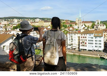 Zurich, Switzerland - September 2, 2016: Two Female Tourists Taking Photos At Limmatquai In Zurich, 