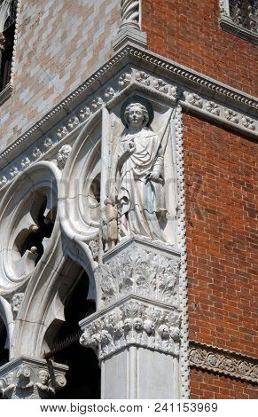 VENICE, ITALY - MAY 28: Sculpture of Archangel Raphael with Tobias, detail of the Doge Palace, St. Mark Square, Venice, Italy, UNESCO World Heritage Sites on May 28, 2017.