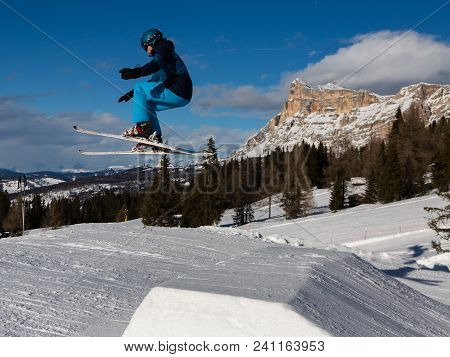 Skier In Action: Ski Jumping In The Mountain Snowpark.