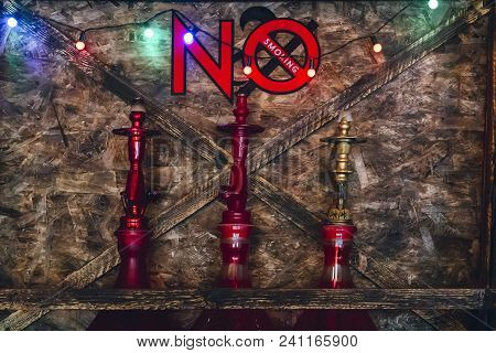 Three Hookahs On The Shelf Under The Inscription Not To Smoke