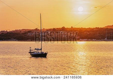 Sunrise With Boat At Costa Smeralda At Mediterranean Sea, Sardinia, In Italy