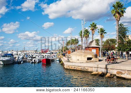 ALGHERO, ITALY -SEPTEMBER 17, 2017: People at the port of Alghero, Sardinia, Italy, next to the Centro Storico, the old town of the city