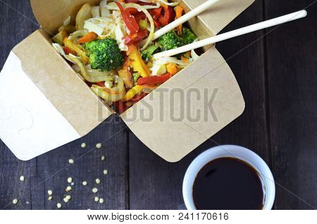Chinese Or Korean Food Noodles On Sticks. In The Card Box Take Out Or To Go. Soy Sauce. With Vegetab