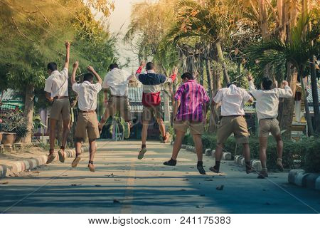 Group Of Friends Having Fun On Street In Primary School.