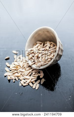 Edible Dried Raw Organic Seeds Of Musk Melon Or Cantaloupe Or Tati Or Honeydew On A Wooden Surface.