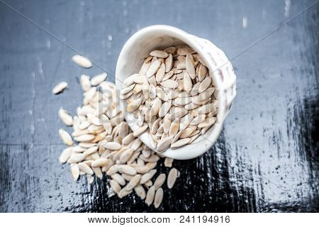 Edible Dried Raw Organic Seeds Of Musk Melon Or Cantaloupe Or Tati Or Honeydew On A Wooden Surface.