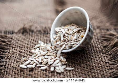 Edible Dried Raw Organic Seeds Of Musk Melon Or Cantaloupe Or Tati Or Honeydew On A Wooden Surface.