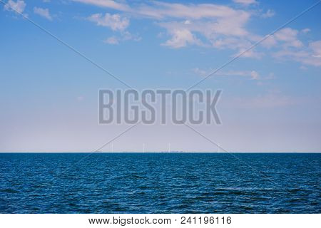 The Blue Ocean With Dull Clouds On A Lovely Sunny Day