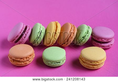 Multicolored Macaroons Isolated On Fucsia Background, Close Up
