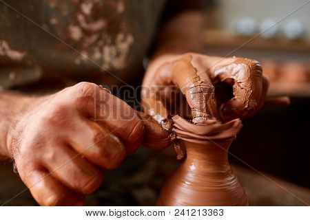 Close-up Hands Of A Male Potter In Plaid Shirt And Dirty Apron Who Molds Bowl From Clay, Selective F