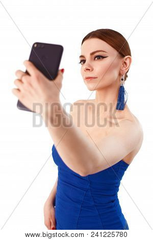 Full Length Portrait Of A Cheerful Smiling Woman Taking Selfie