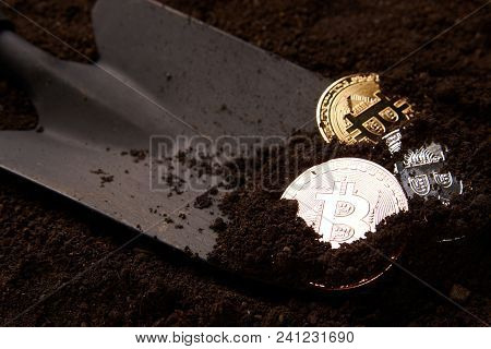 Virtual Cryptocurrency Mining Concept, Close-up. Bitcoin Gold Coins, Silver And Bronze And Shovel Ga