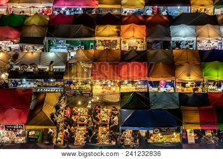 BANGKOK, THAILAND, MARCH 16, 2018 : Close shot on the colorful Rod Fai Ratchada night market with people having diner in Bangkok, Thailand
