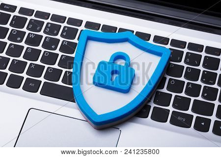 High Angle View Of A Blue Shield Security Sign On Laptop Keypad