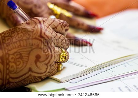 A Newly Married Indian Bengali Wife With Golden Wedding Ring Signing Marriage Registration Form