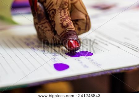 Lady Giving Thumb Impression On Marriage Registry Certificate. Indian Matrimony. Bengali Weddding