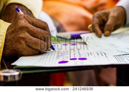 Hand Of An Old Man Writing Important Legal Document
