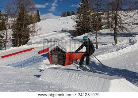 Skier In Action: Ski Jumping In The Mountain Snowpark.