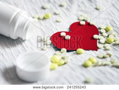 Red Heart Shape With A Pills On The White Fabric Background