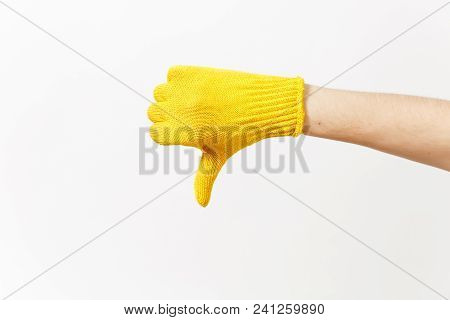 Close Up Of Female Hand In Building Yellow Gloves Showing Thumb Down Isolated On White Background. A