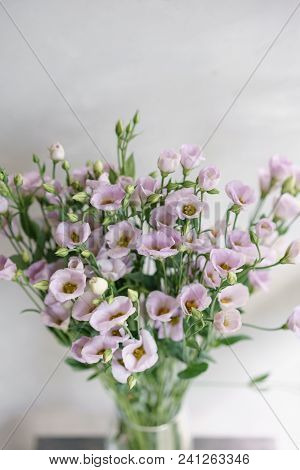 Bunch Of Lilac Eustoma Flowers In Glass Vase. Love Vintage Background With Flowers