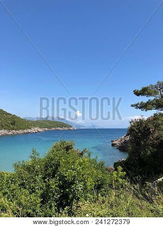 Aerial View Of The Coast Of Montenegro.  Turquoise Sea Water On The Ploce Beach.