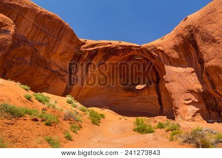 Eye Of The Eagle Big Hogan. Pothole Natural Arch Eroded In Sandstone. Navajo Tribal Park Of Monument
