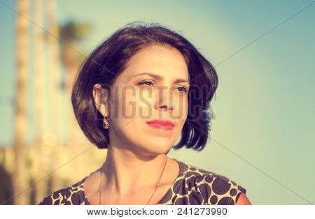 Brunette Girl On The Coast Of The Mediterranean Sea, Looks Into The Distance.